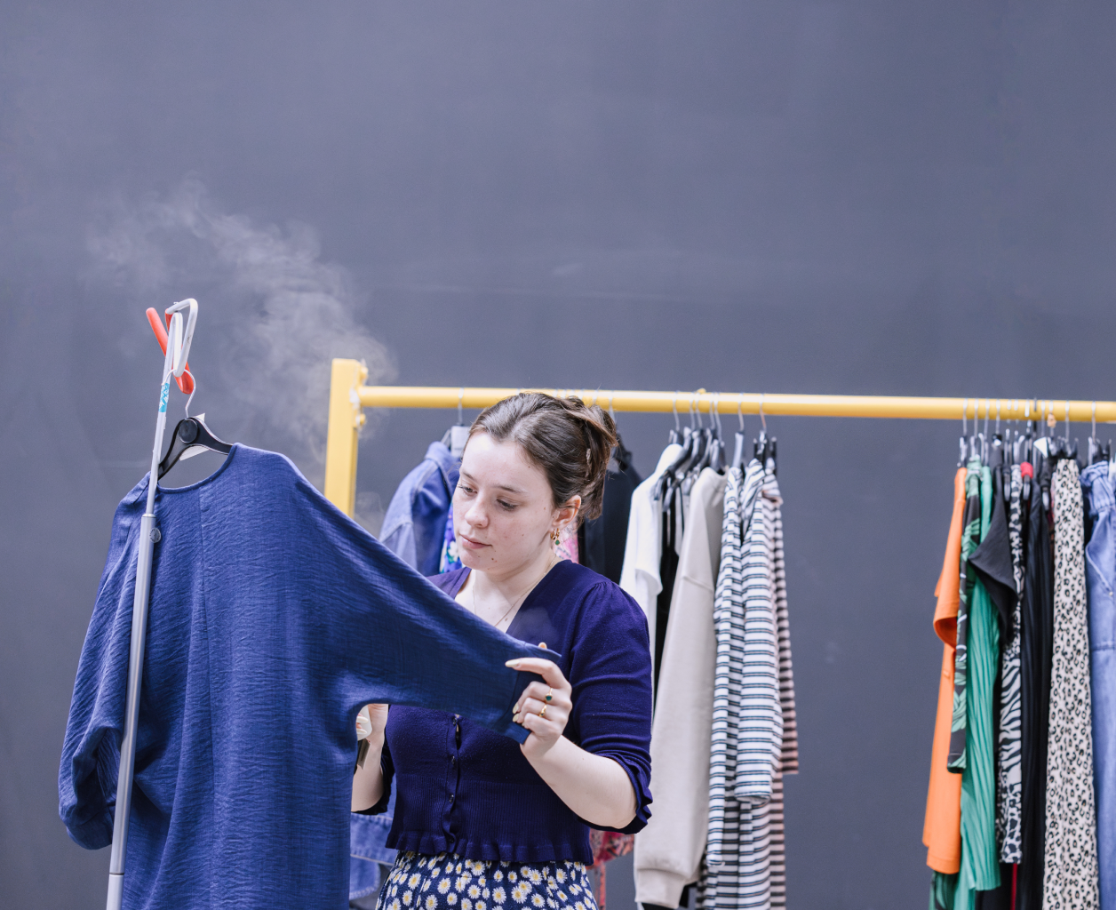 Steaming clothes on rail